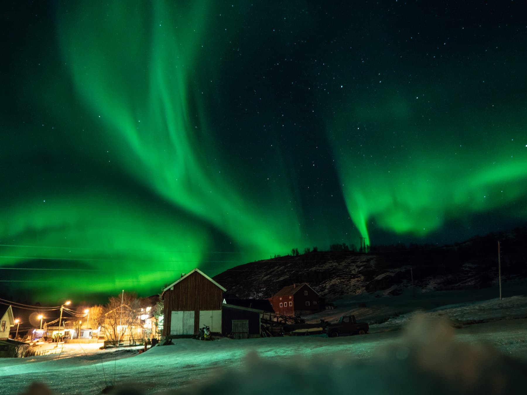 northern lights above houses of Spildra village